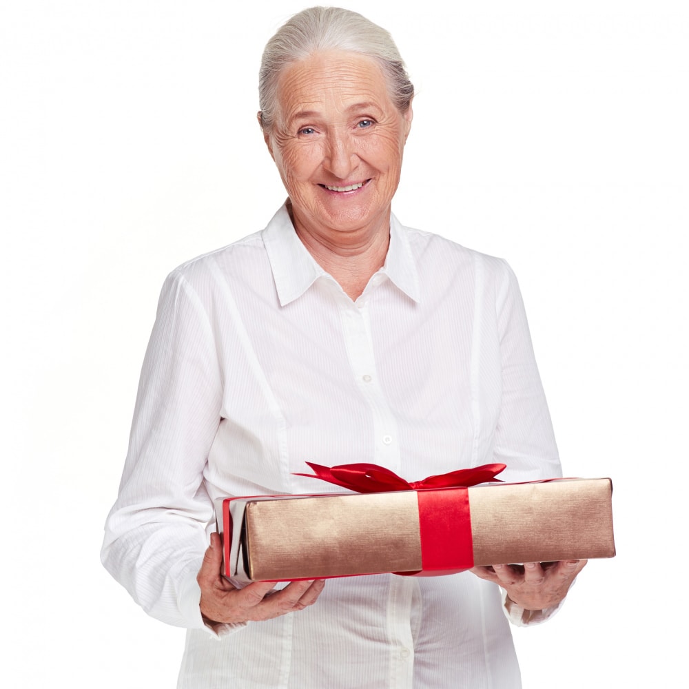 senior-woman-holding-gift-with-red-bow
